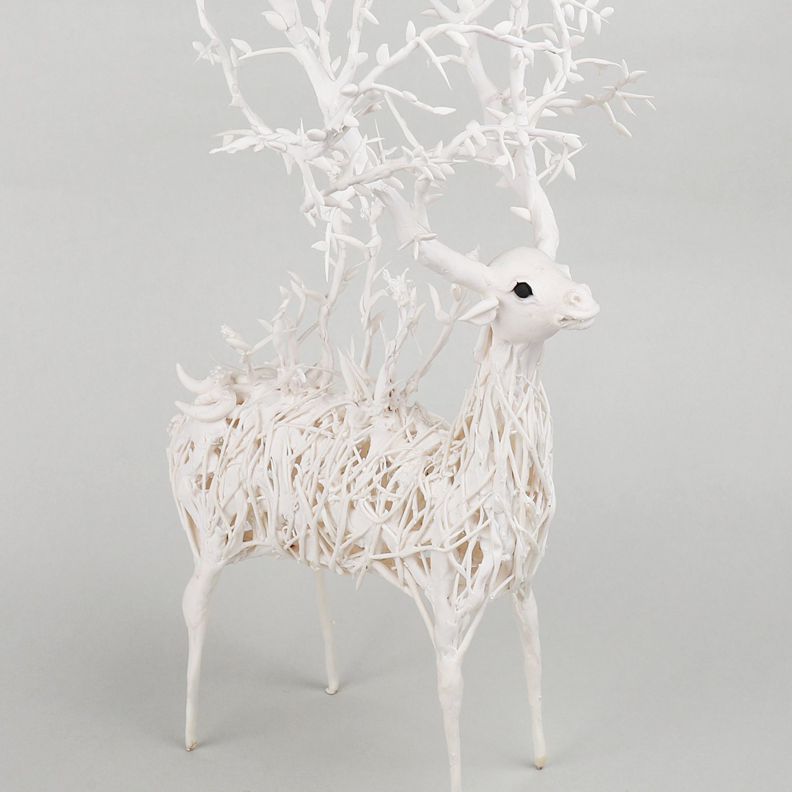 The white wire deer figure that stands for the brand
